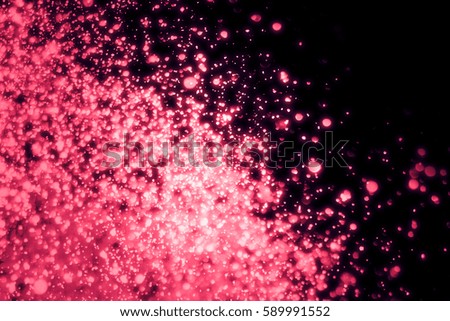 Red abstract sparkles or glitter lights. Festive  background. Defocused circles bokeh or particles. Template for design.