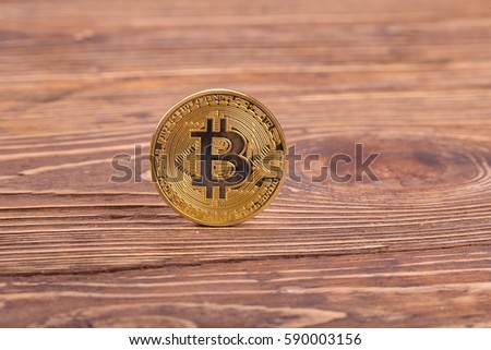 golden bitcoin on wooden  background