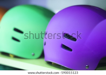 Inline and quad roller skates helmets head protection in retail skate shop display on sale.