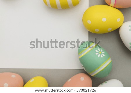 Easter holiday background. Pastel coloured decorated easter eggs with a blank white label.