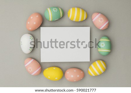 Easter holiday background. Pastel coloured decorated easter eggs with a blank white label.