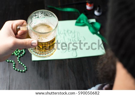 Man drinking beer and celebrating St Patrick day  close up