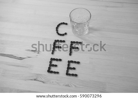 The inscription is coffee made from coffee seen on wooden background, the circle is in the center