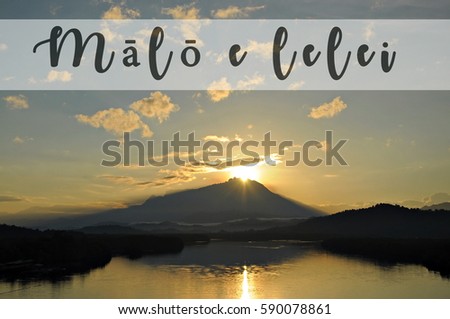 Image with the text MALO E LELEI, Tongan word for good morning with beautiful sun rising from behind a mountain. Concept idea for greeting, tourism, language teaching and for background purposes.