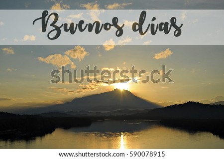 Image with the text BUENOS DIAS, Spanish word for good day with beautiful sun rising grandly from behind a mountain. Concept idea for greeting, tourism, language teaching and for background purposes.