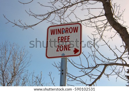 Windrow Free Zone Sign Against Blue Sky.