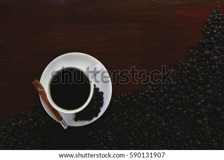 Coffee cup and beans on old table.. Top view with copy space for your text
