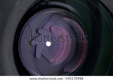 The diaphragm of a camera lens aperture. Selective focus with shallow depth of field.