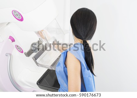 Woman Undergoing Mammogram X-ray Test In Hospital Royalty-Free Stock Photo #590176673