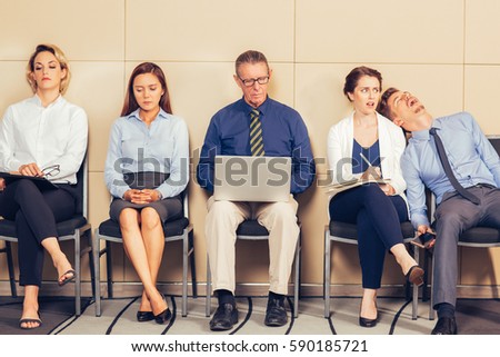 Five Bored Business People Sitting in Waiting Room