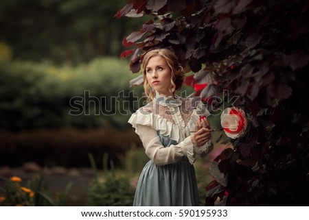 the girl in the blue dress in the garden