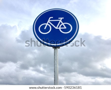 Bicycle lane, round blue road sign in Amsterdam, Netherlands