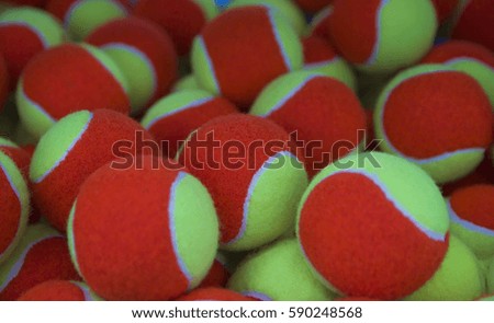 lot of bright yellow red tennis balls as a background.
