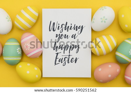 Seasonal Easter message with decorated Easter eggs  Royalty-Free Stock Photo #590251562