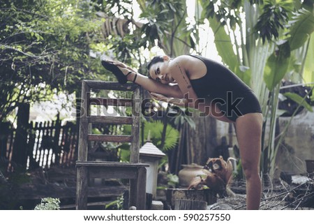 Beautiful woman meditates while practicing ballet. Freedom Beauty fitness woman doing exercises in the garden.Concept of healthy lifestyle.Calmness and relax happiness woman. Toned picture