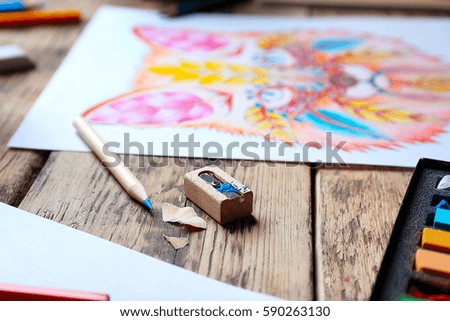 Pencil with sharpener and colouring picture on background