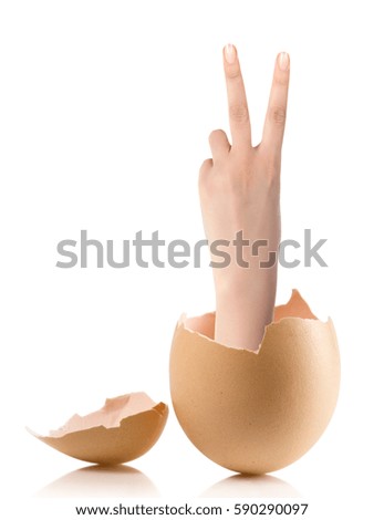 Hand with broken egg isolated on white 