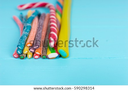 Colorful delicious licorice candies on wooden turquoise board