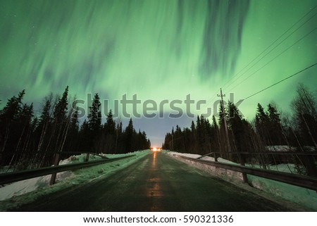 Northern Lights and empty road in Lapland, Finland.