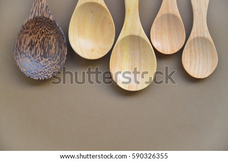 Pattern of wooden spoon with brown background.
