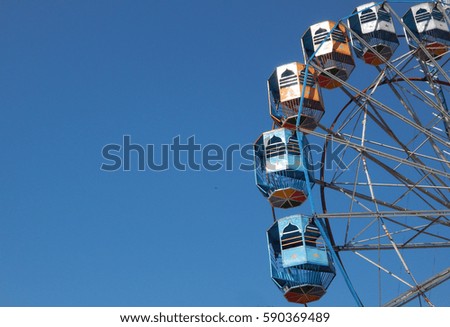 Ferris wheel against blue sky                                