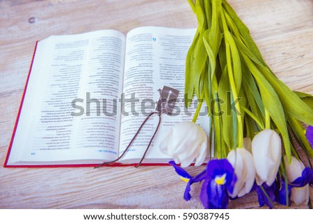 bible and cross on a wooden table