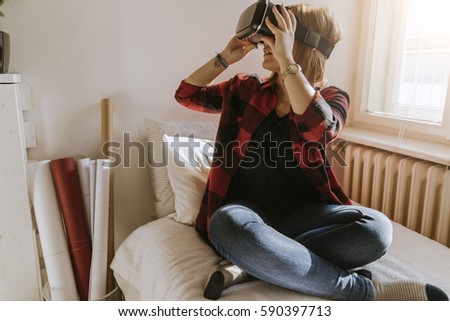 A Young Girl Using VR In The Bedroom