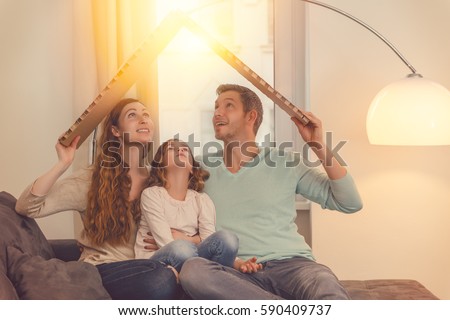 family in house planning with daughter Royalty-Free Stock Photo #590409737