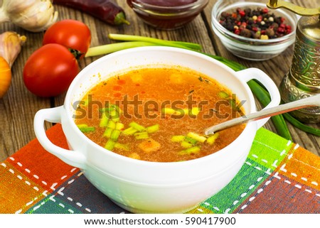 Soup in white bowl on wooden background. Studio Photo