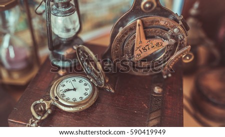 Antique bronze compass and retro adventure accessories in vintage style image.