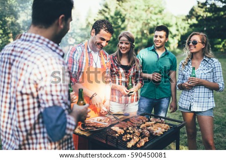 Happy people having camping and having bbq party outdoor Royalty-Free Stock Photo #590450081