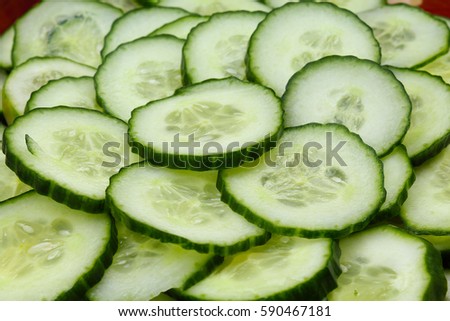Cucumber slices as background. Green fresh cucumbers as background. Cucumber pattern texture. Vegetable food photo.
