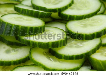 Cucumber slices as background. Green fresh cucumbers as background. Cucumber pattern texture. Vegetable food photo.
