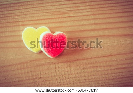 Candy heart on wooden background.