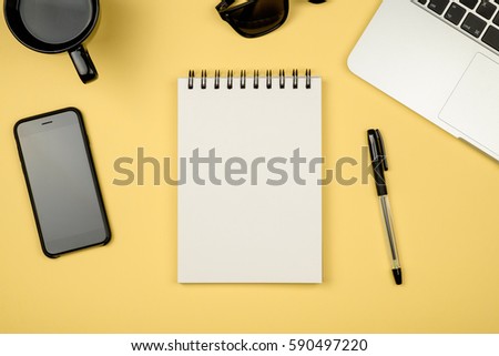 Top view flat lay picture with blank notepad page and different accessories on colored surface
