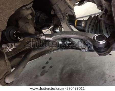 Car spare parts. Close-up of the right side tie rod end in the real case. The new tie rod end. Changing a new car spare part. Royalty-Free Stock Photo #590499011