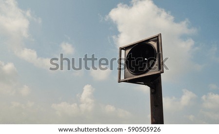 Box of traffic lights with a beautiful blue sky in background.