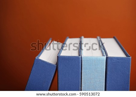 Books in a row on brown background