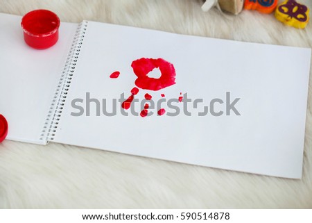 Red palm-print on white paper