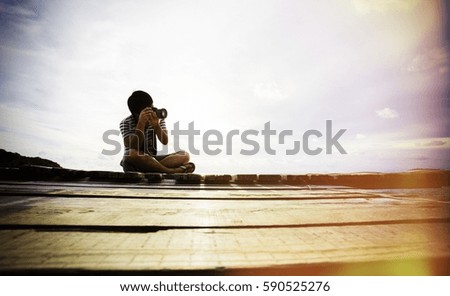 Photographer man sitting at sea.