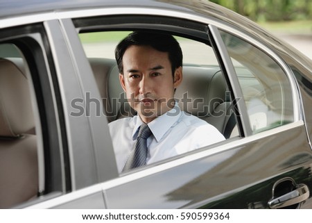 Businessman sitting in car