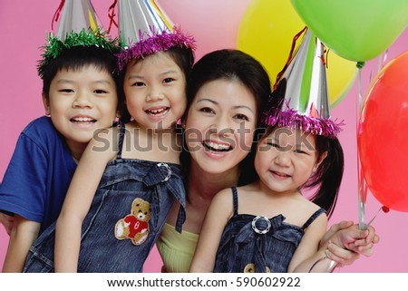 Mother and three children, smiling