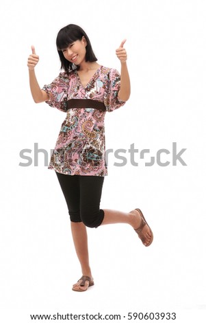Young woman making thumbs up sign