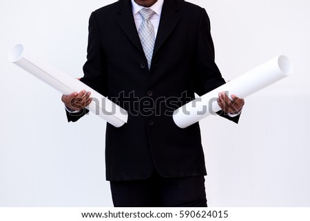 Business man holding a blueprints in his hands.
