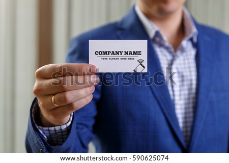 Businessman holding visit card. Man showing blank business card with phone icon. Person in blue suit. Mock up design.