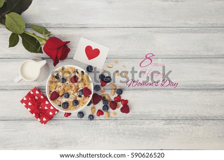 the text 8 March, observance of the womens day on a table set for breakfast, with a bowl with cereals 