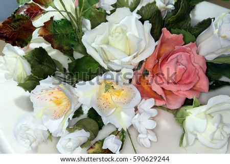 macro expertly made beautiful flowers on the cake on a light background studio 