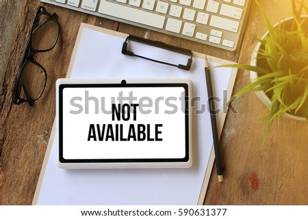 NOT AVAILABLE CONCEPT ON TABLET PC SCREEN Royalty-Free Stock Photo #590631377