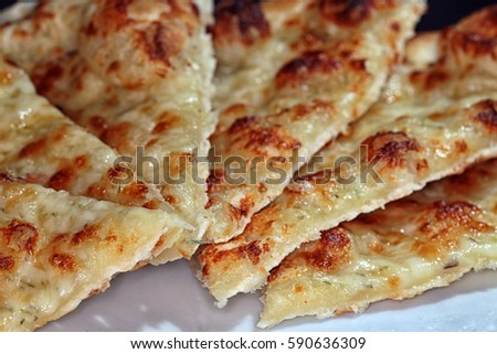 Macro appetizing pizza with cheese on a dark background studio