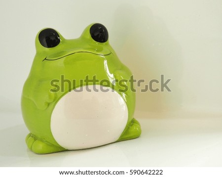 green frog piggy bank isolated background